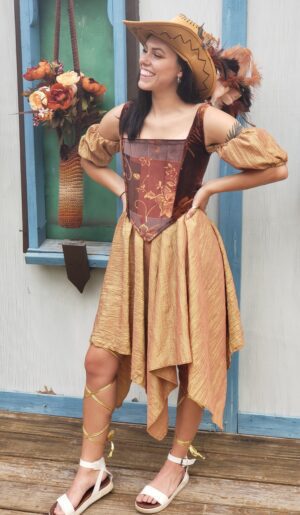 Woman In Gold Dress, Russet Corset, And Hat With Feathers
